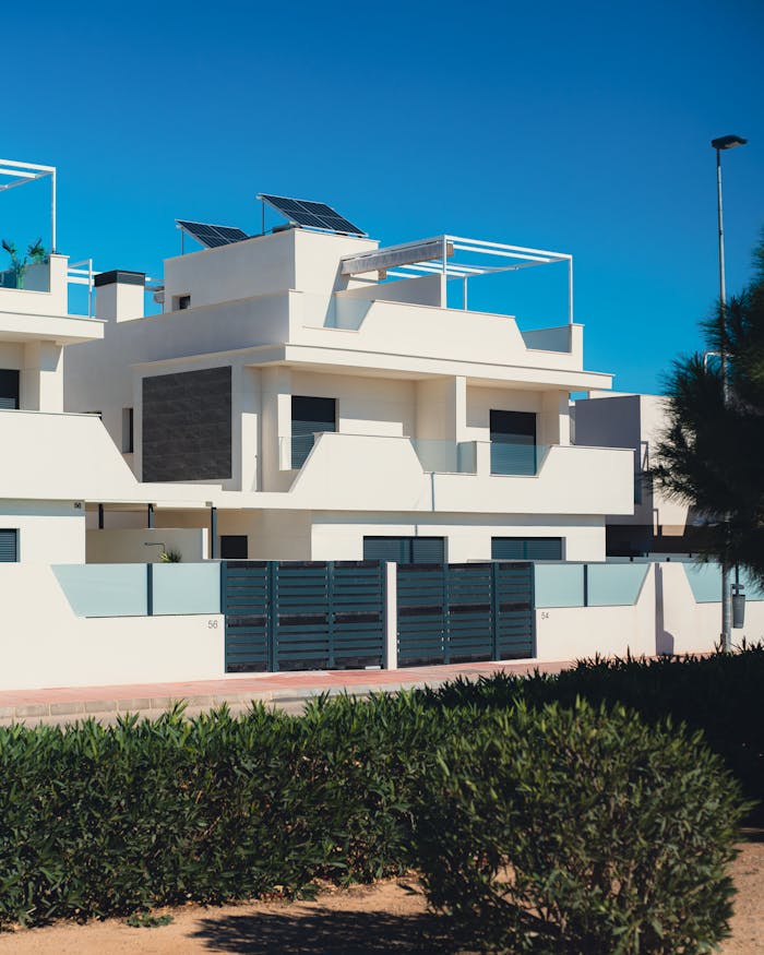 about-us Contemporary white villas with solar panels in Santiago de la Ribera, Spain.