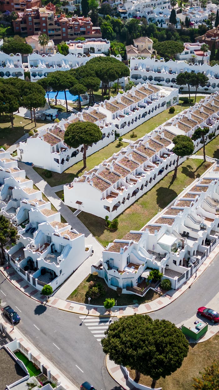 heros-img Stunning aerial view of traditional whitewashed villas in Marbella, AndalucĂa.